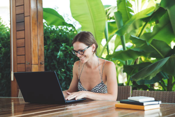 Young woman doing some on-line classes staying at home. Self isolation concept.